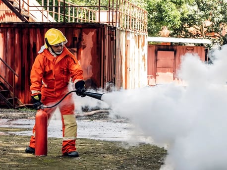 Foam Fire Extinguisher being used outdoors by firefighter