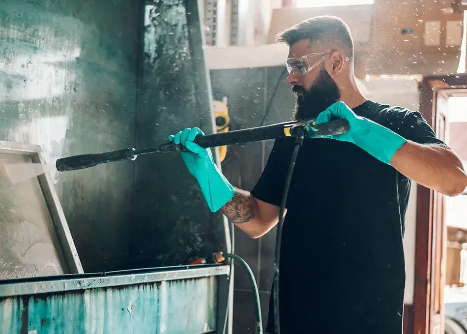 Worker using pressure washer